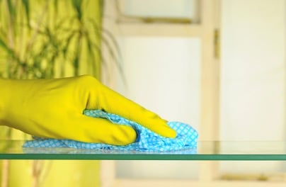 Person's hand cleaning a table